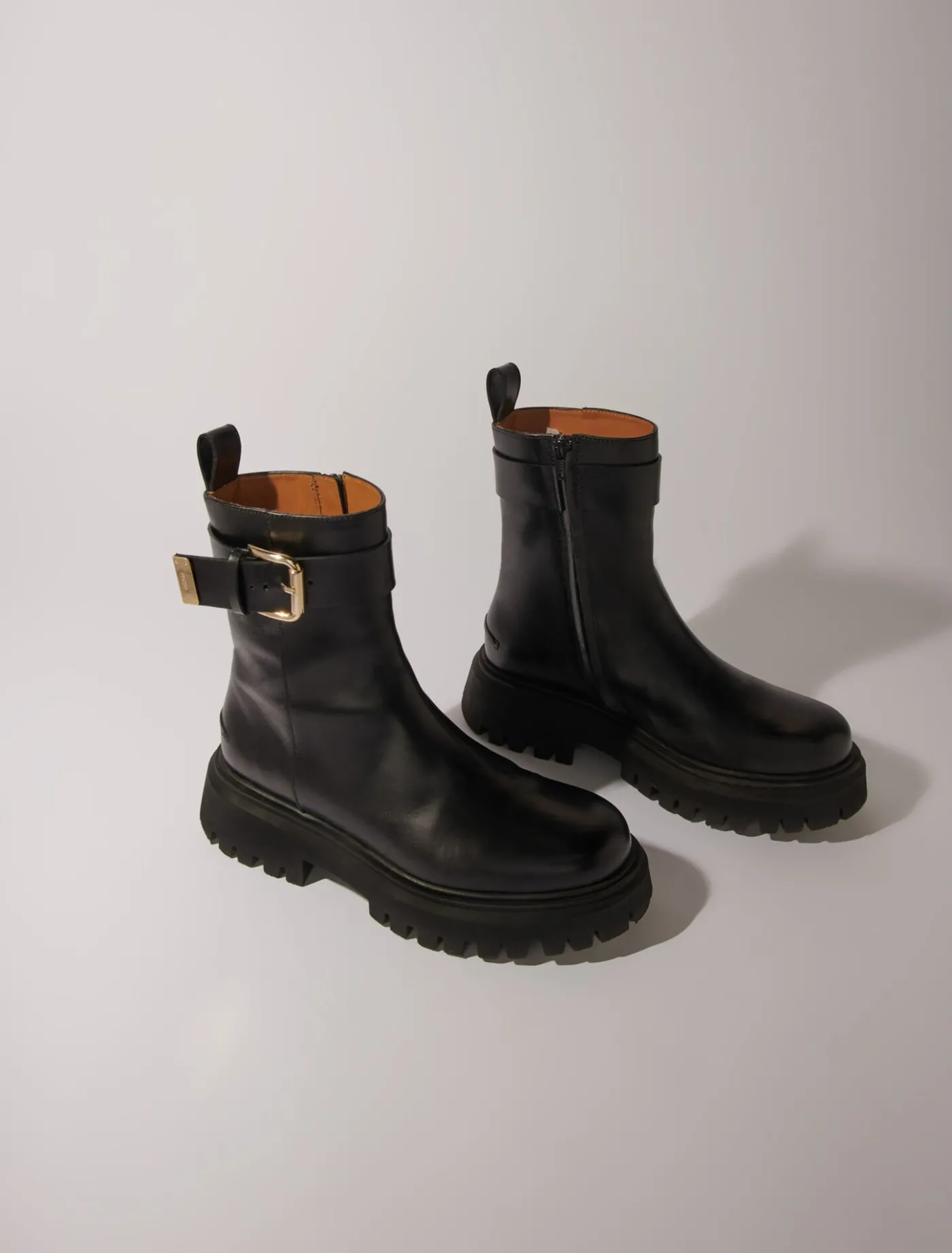 leather_ankle_boots_with_buckles_3.webp Leather ankle boots with buckles^Maje Discount